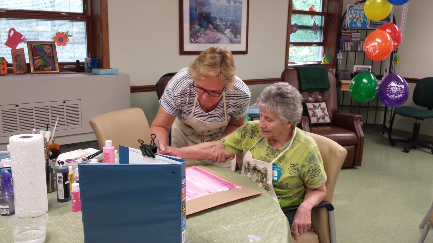 Learning to paint at the Wayne County Adult Day Living Center.